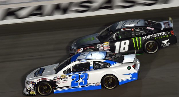Bret Holmes, driver of the #23 Holmes II Excavation Chevrolet, and Riley Herbst, driver of the #18 Monster Energy/Terrible Herbst/ORCA Toyota, race during the ARCA Menards Dawn 150 on July 24, 2020 at Kansas Speedway in Kansas City, Kansas. (Ed Zurga/ARCA Racing)