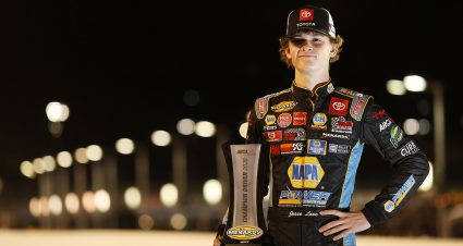 Jesse Love, driver of the No. 19 NAPA Power Premium Plus Toyota, poses for a photo with the ARCA Menards Series West championship trophy at Phoenix Raceway in Avondale, Arizona, on Nov. 7, 2020 (Christian Petersen/Getty Images)