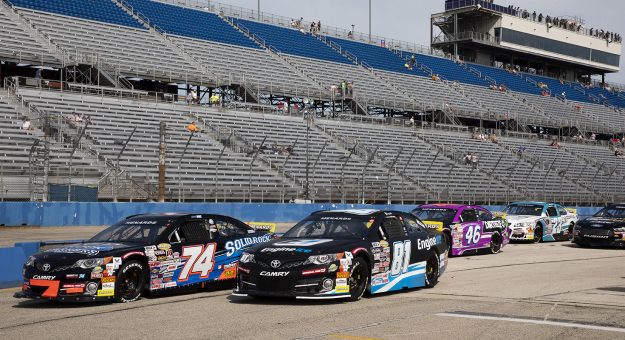 Race cars wait on pit lane for the start of practice before the Sprecher 150 for the ARCA Menards Series at the Milwaukee Mile in West Allis, Wisconsin, on Aug. 29, 2021. (Patrick McDermott/ARCA Racing)