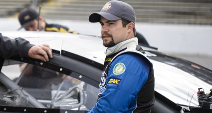 Mason Mingus driver of the No. 11 Team Construction Ford leans against his car before the qualifying round for the Crosley Record Pressing 200 for the ARCA Menards Series East at Nashville Fairgrounds Speedway in Nashville, Tennessee, on May 8, 2021. (Silas Walker/ARCA Racing)