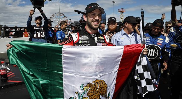 SONOMA, CALIFORNIA - JUNE 12: Daniel Suarez, driver of the #99 Onx Homes/Renu Chevrolet, celebrates with a Mexican flag after winning the NASCAR Cup Series Toyota/Save Mart 350 at Sonoma Raceway on June 12, 2022 in Sonoma, California. (Photo by Chris Graythen/Getty Images) | Getty Images