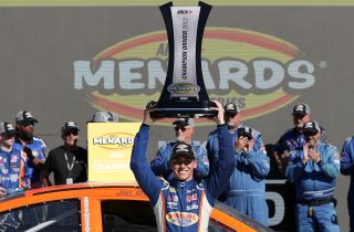AVONDALE, ARIZONA - NOVEMBER 04: Jake Drew, driver of the #6 Sunrise Racing-Molecule-Group A Ford, lifts the 2022 ARCA Menards Series West trophy in victory lane after winning the 2022 ARCA Menards Series West championship after the ARCA Menards Series West Desert Diamond Casino West Valley 100 at Phoenix Raceway on November 04, 2022 in Avondale, Arizona. (Photo by Meg Oliphant/Getty Images) | Getty Images