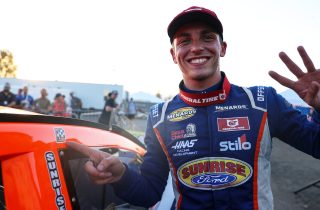 Jake Drew, driver of the #6 Sunrise Racing-Ford Performance-Molecule, places a victory sticker on his car during the Portland 100 for the ARCA Menards Series West at Portland International Raceway in Portland, Oregon on September 3, 2022. (Brian Hayes/ARCA Racing)