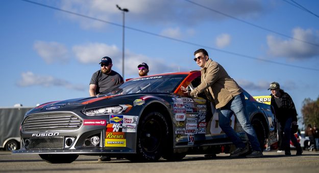Crew members move the car of Becca Monopoli